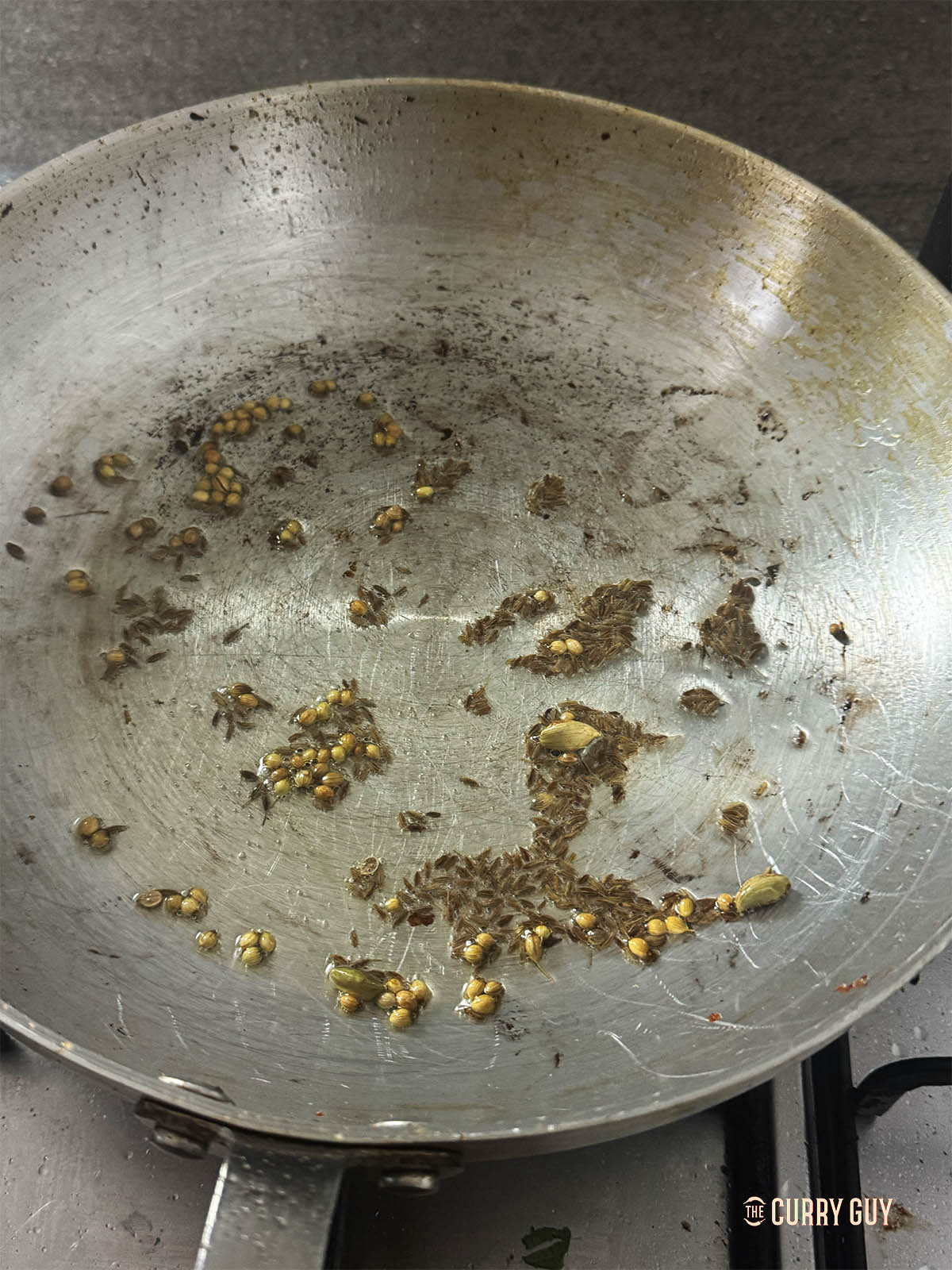 Infusing the whole spices in oil for 30 seconds.