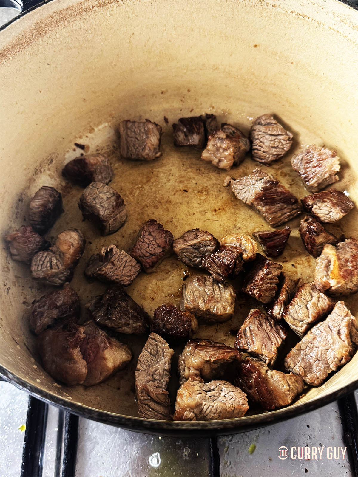 Searing the beef in oil. 