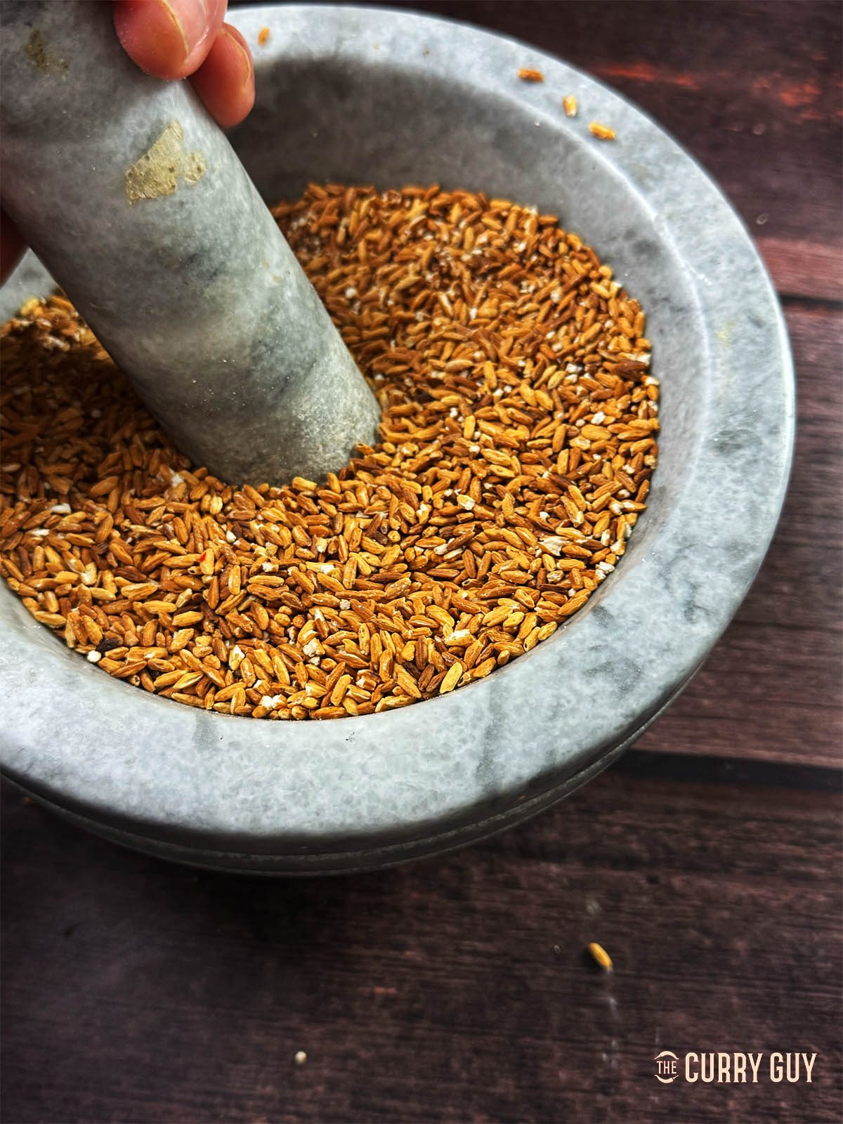 The toasted rice in a pestle and mortar.