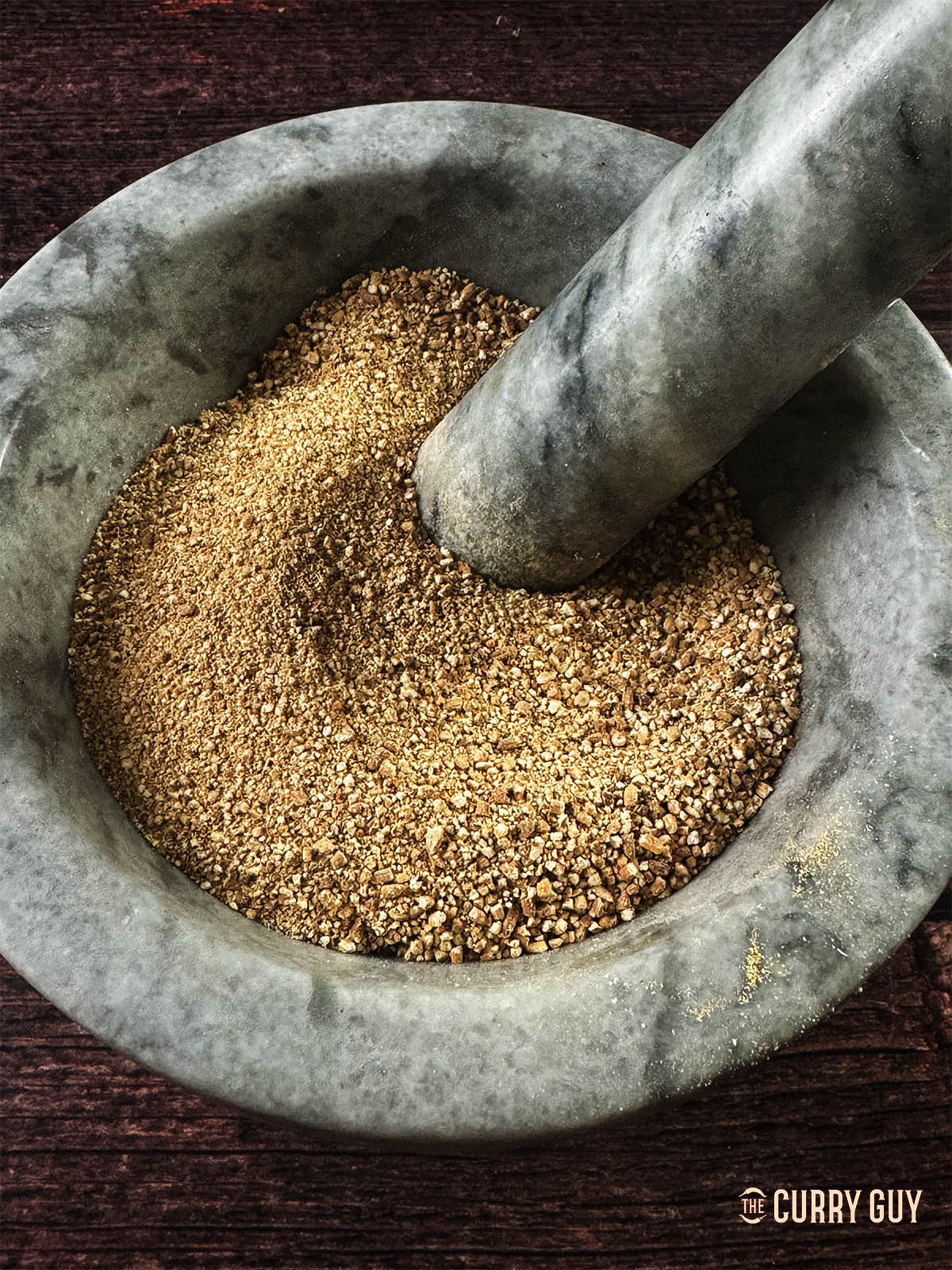 Then rice coarsely ground to a sandy consistency. 