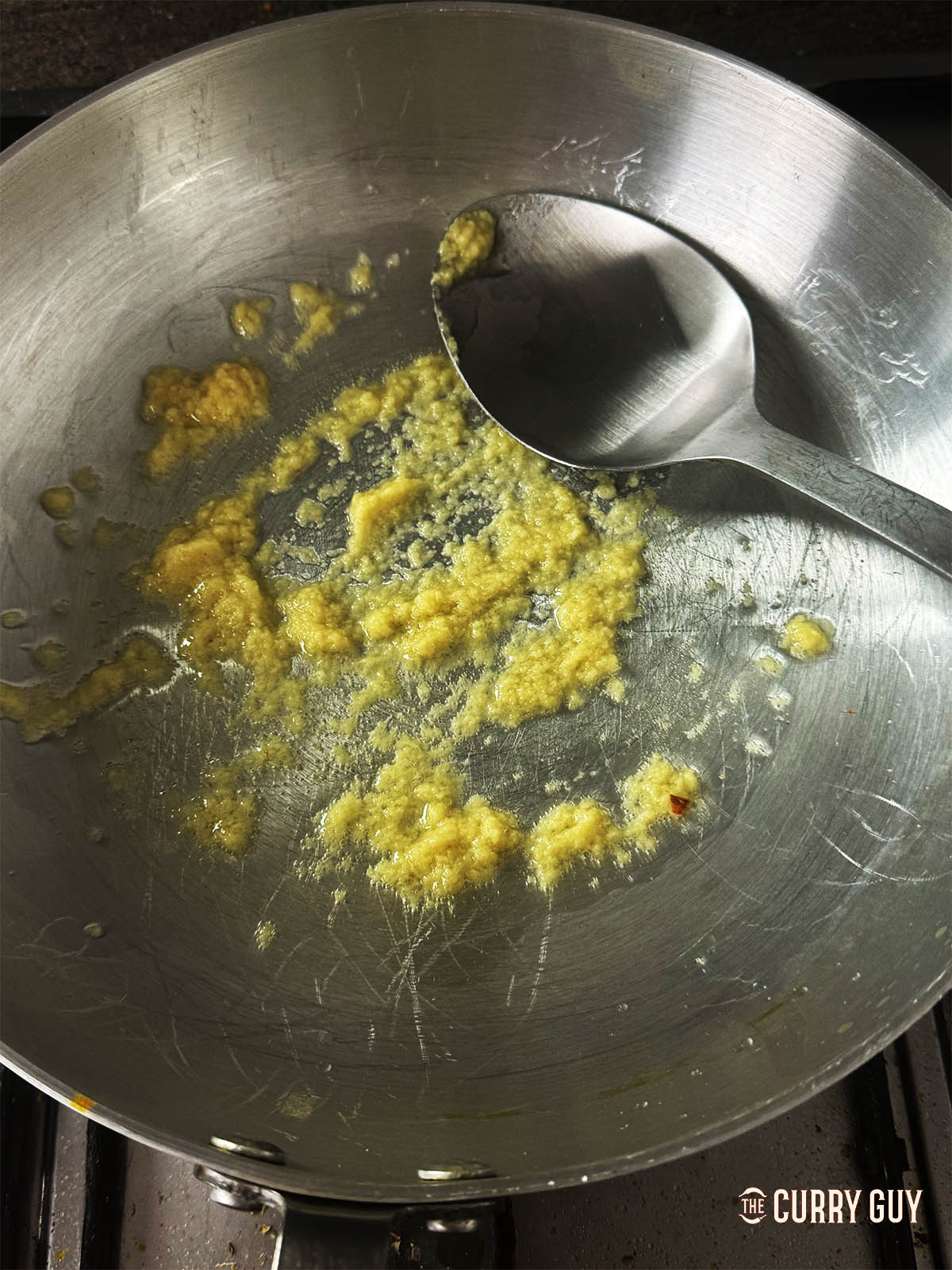 Frying the garlic and ginger paste in the pan. 