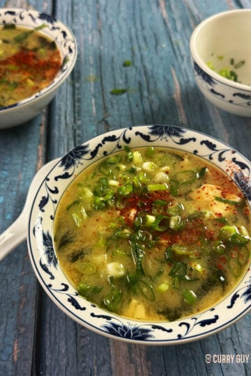 Miso soup garnished with Japanese chilli flakes.