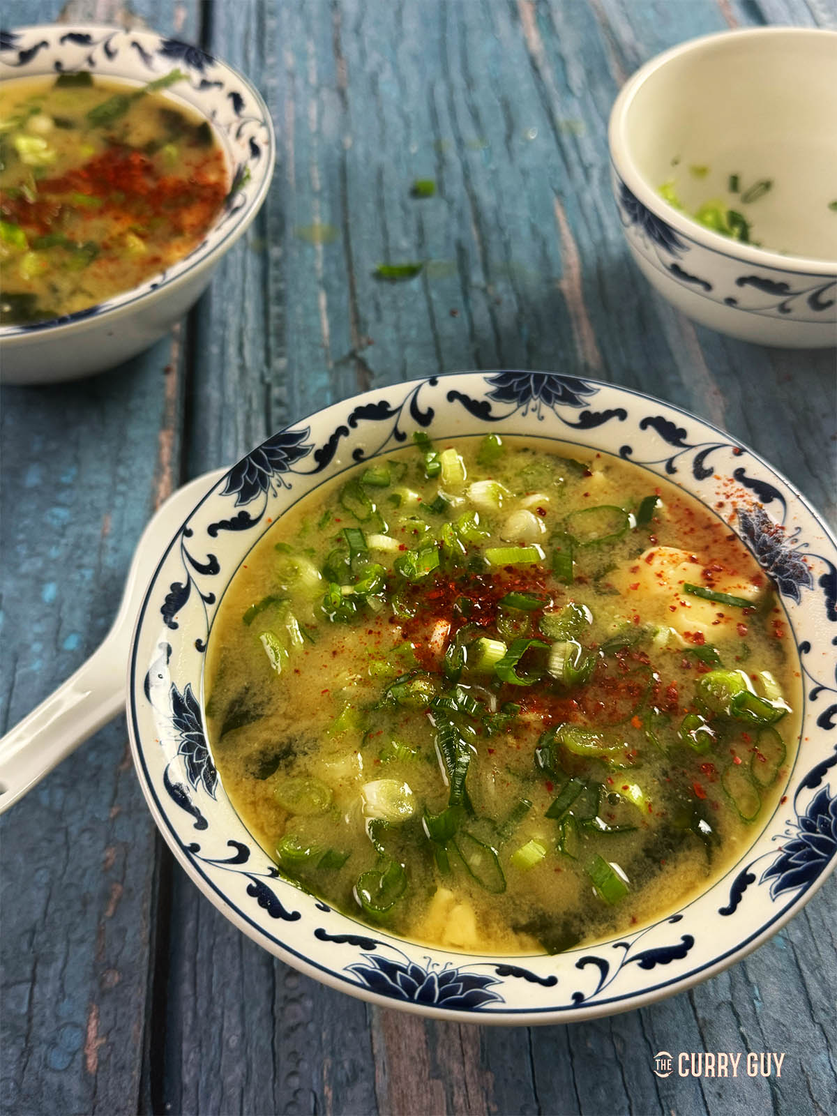 Miso soup garnished with Japanese chilli flakes.