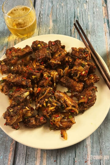 Salt and pepper ribs on a serving plate.