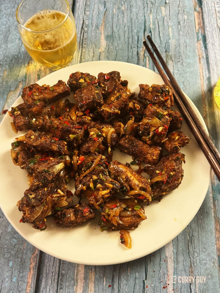 Salt and pepper ribs on a serving plate.