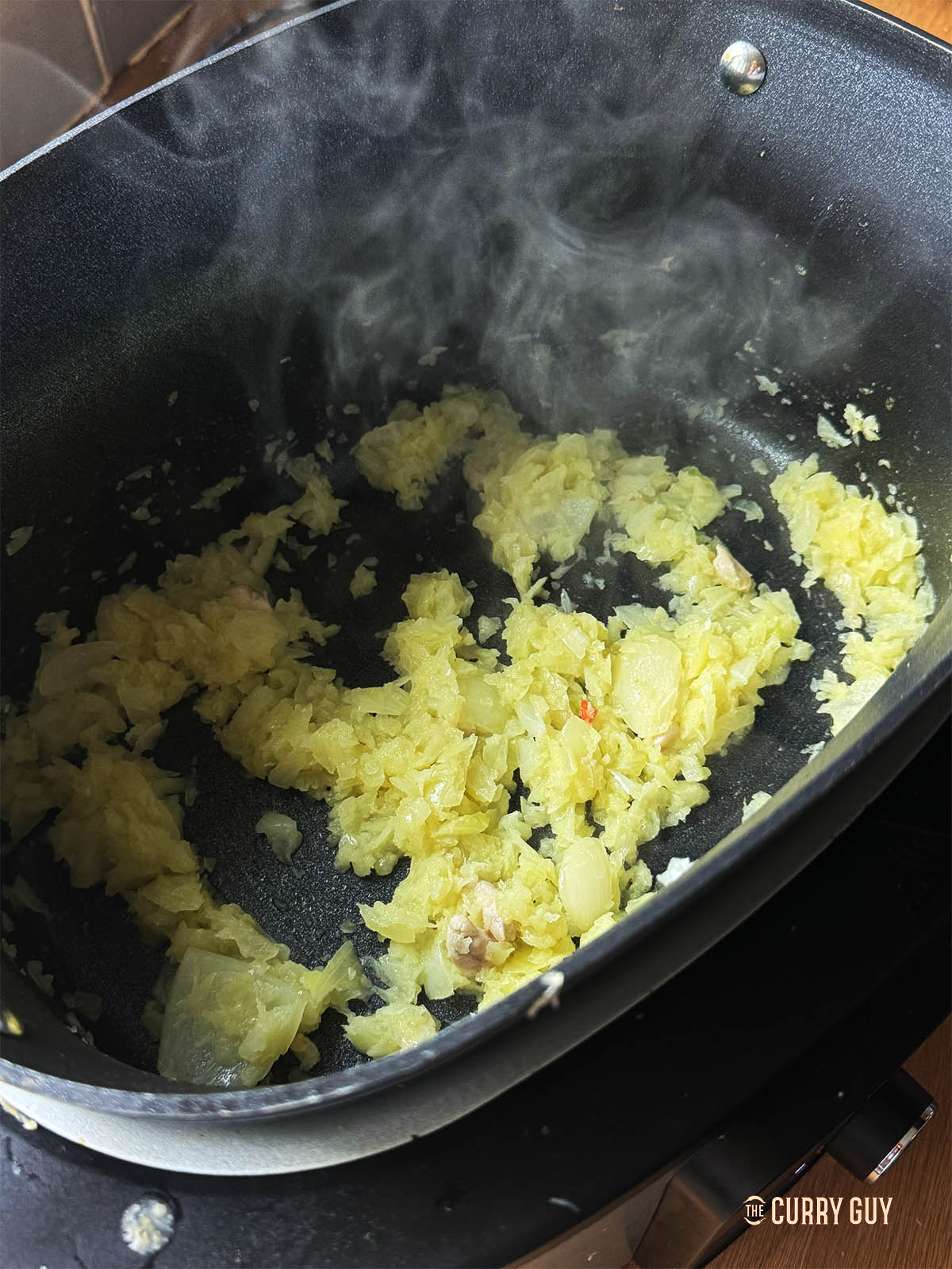 Sautéing chopped onions in the slow cooker using sauté function. 