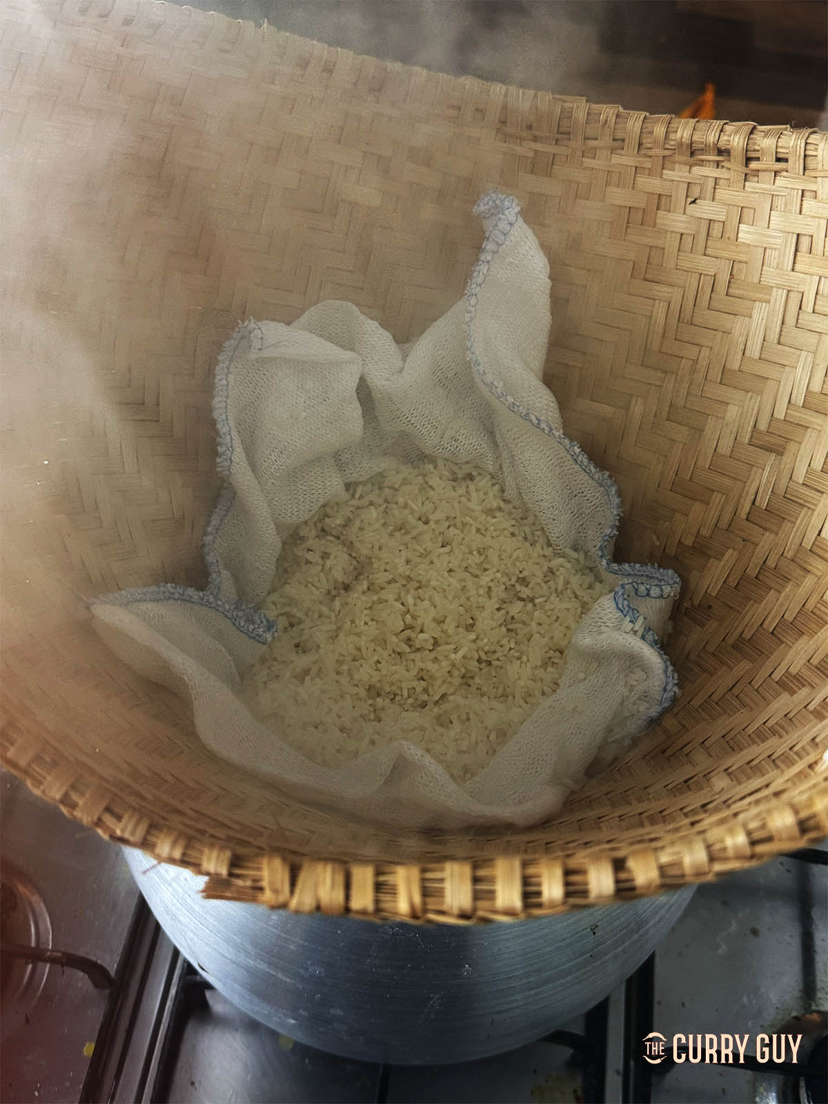 The rice in a bamboo steaming basket.